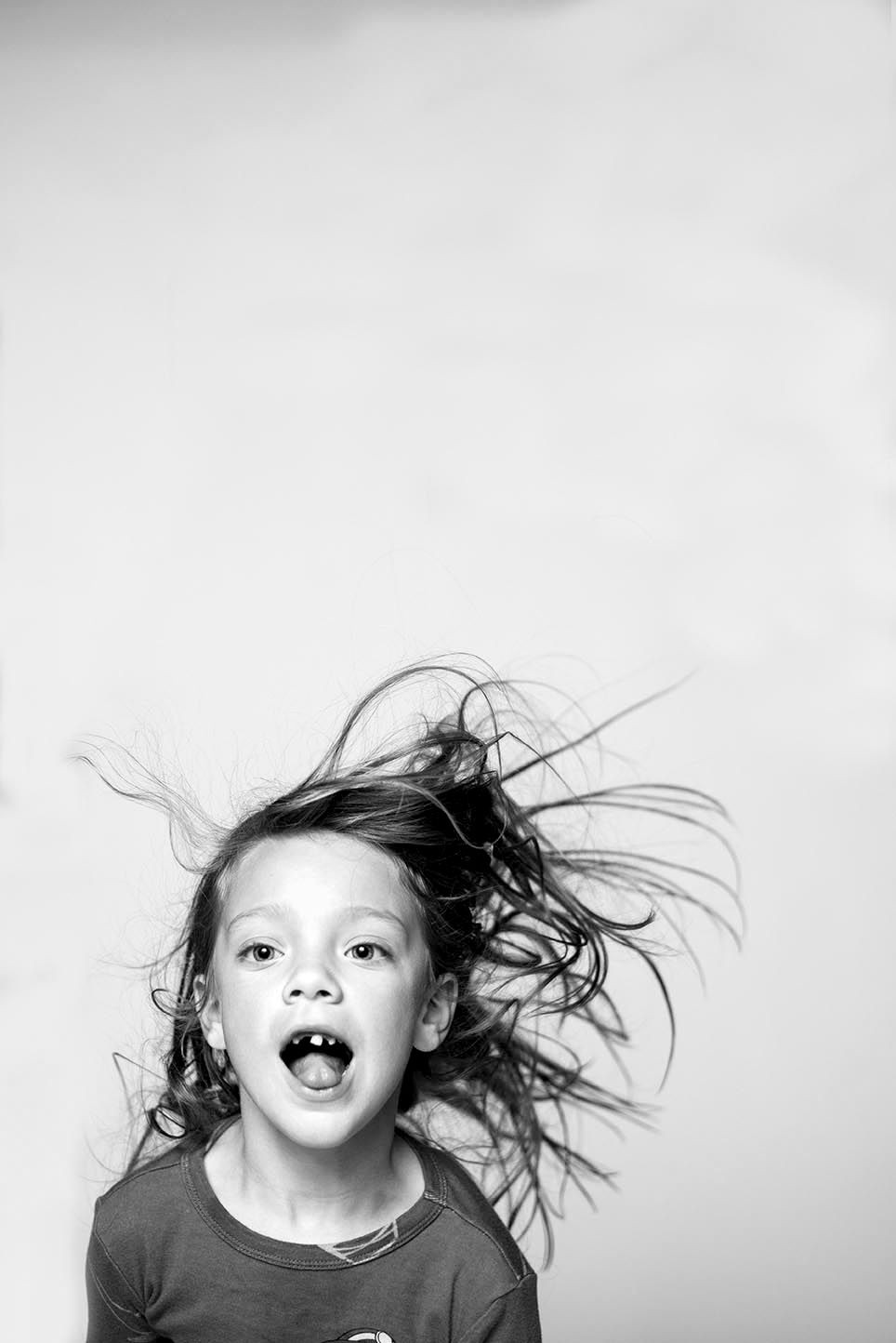 black and white portrait of a child being silly