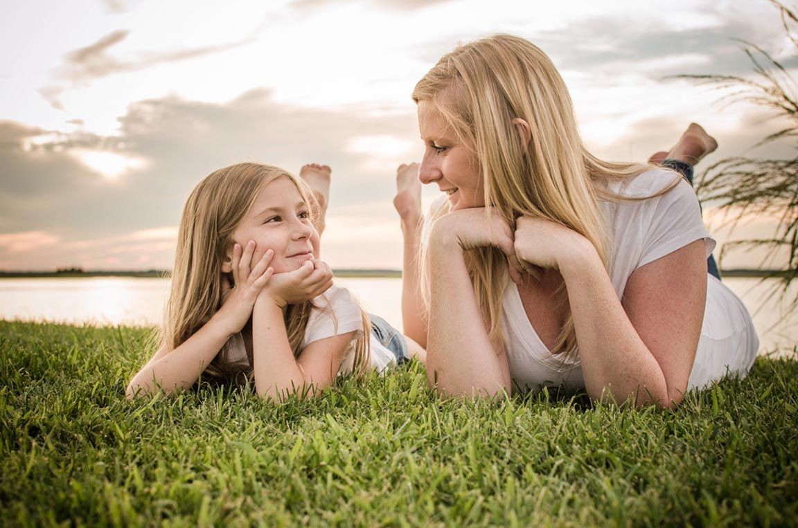 mother daughter photo on the lake at sunset